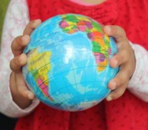 Earth Globe In Childs Hands